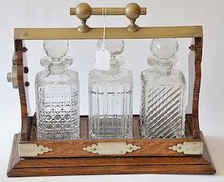 Oak tantalus with three various crystal bottles. 
height 12 1/2 inches, length 16 inches 
***If this lot is not picked up on Sat. 9/...