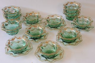 Set of twenty-two green crystal finger bowls and under plates with gilt rim and gilt flower wreath border including fifteen finger b...