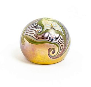 An Orient and Flume Iridescent Glass Paperweight, Diameter 3 inches.