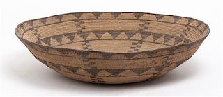 A Native American Coil Basket, Height 3 1/4 x width 16 inches.