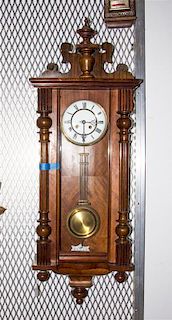 A Viennese Walnut Regulator Clock, Height 43 inches.