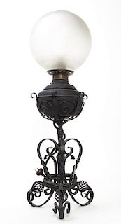 A Victorian Iron Oil Lamp, Height overall 31 1/2 inches.