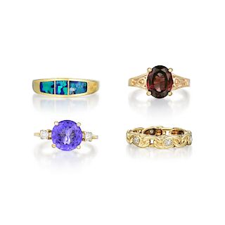 A Group of Four Gold Diamond and Colored Stone Rings