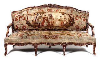 A Louis XV Style Needlepoint Settee Height 40 x width 75 x depth 28 inches.