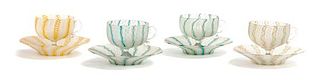 A Set of Four Venetian Ribbon Glass Cups and Saucers Height of cup 2 1/2; diameter of saucer 5 inches.