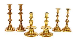 A Group of Brass Candlesticks Height of tallest pair 10 inches.