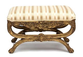 An Italian Rococo Style Painted and Parcel Gilt Curule-Form Tabouret Height 20 inches.