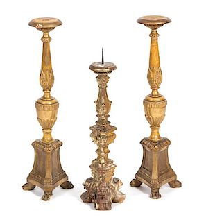 A Group of Three Italian Rococo Style Carved Giltwood Pricket Candlesticks Height of taller 22 1/2 inches.