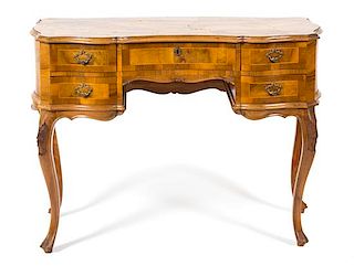 An Italian Rococo Style Walnut Serpentine Desk Height 31 1/4 x width 42 x depth 20 inches.