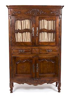 A French Provincial Carved Fruitwood Buffet a Deux Corps Height 79 1/2 x width 50 3/4 x depth 21 1/2 inches.