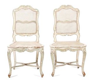A Pair of Louis XV Style Carved and Painted Caned Back and Seat Side Chairs Height 38 1/2 inches.