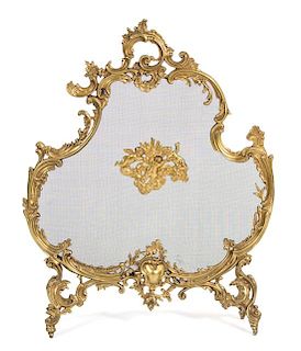 A Louis XV Style Gilt Bronze and Wire Mesh Cartouche-Form Fire Screen Height 33 3/4 x width 26 1/2 inches.