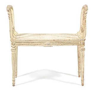 A Louis XVI Style Carved and Painted Cane Seat Window Bench Height 29 1/2 x length 30 inches.