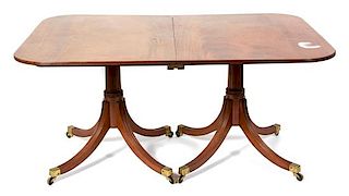 A Regency Style Two Pedestal Mahogany Dining Table Height 28 1/2 x width 59 3/4 x depth 42 1/4 inches.