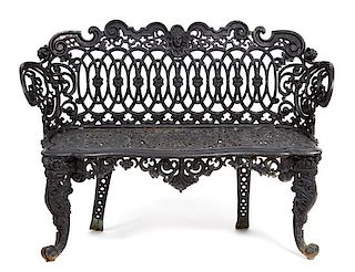 A Victorian Three-Piece Painted Iron Garden Suite Height of bench 33 x width 44 1/4 inches.