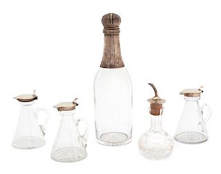 A Group of English Silver Capped Cruets and Bottles, Various Makers, comprising three glass cruets with hinged silver lids, a cu