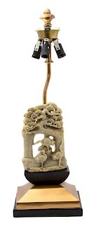 A Chinese Carved Soapstone Sculpture Mounted as a Lamp Height of soapstone 6 1/2 inches, lamp 19 inches.