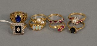 Eight gold rings with various stones. 24.6 grams