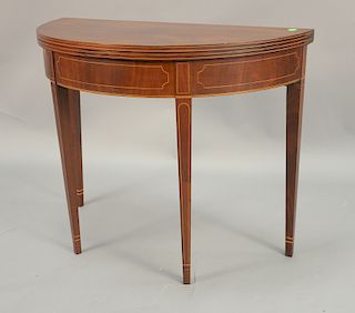 Mahogany demilune game table. ht. 29 in., wd. 36 in.