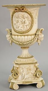 Large porcelain urn with heads handles and figural plaques. ht. 16 in.
