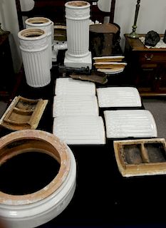 Two piece group including white glazed ceramic cylindrical stove with brass bands (apart) and a white glazed pedestal.