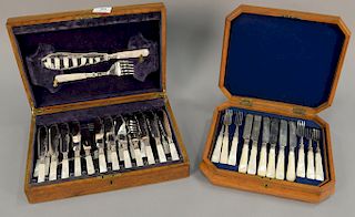 Two pearl handled fish sets in fitted boxes, one with twelve knives, 11 forks, and 3 serving pieces and the other is English silver ...