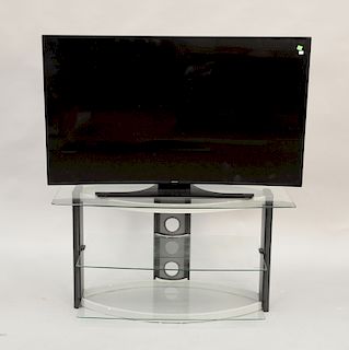 Samsung curved UHD 55 inch TV, three tier glass stand, and miscellaneous electronics, ht. 24 in.