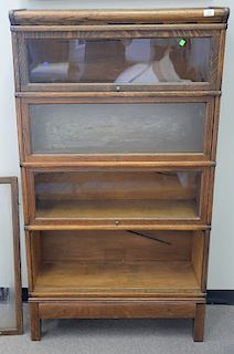 Oak four section stacking bookcase, (two glass panels sick, door is off). ht. 63in., wd. 34in.
