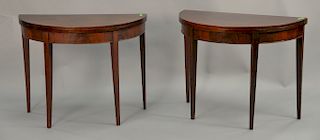 Pair of mahogany demilune games tables. ht. 30 1/2 in., wd. 38 in., dp. 19 in.
