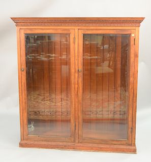 Contemporary two door bookcase with beveled glass doors, ht. 60 in., wd. 57 in..