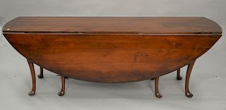 Queen Anne style harvest type drop leaf table with eight legs. ht. 29 in., wd. 82 in.