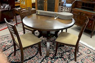 Contemporary table and four chairs with built in leaf. ht. 30 in., top closed dia. 48 in.