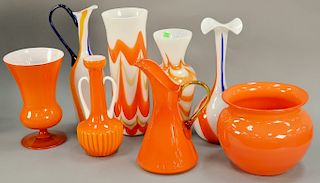 Eight piece Murano art glass group to include two orange and white vases; orange, blue, and white vase; pitcher; and four solid oran...