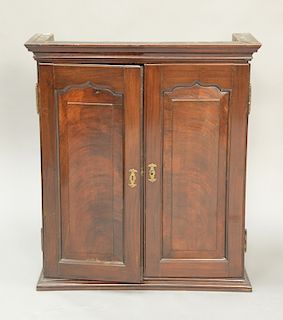 George III mahogany two door cabinet with thirteen fitted interior drawers. ht. 36 in., wd. 27 in.
