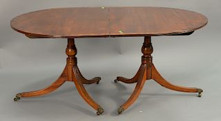 Mahogany double pedestal dining table with base wood banded inlaid top and two 16 inch leaves. ht. 29 in., top closed: 62" x 44", op...
