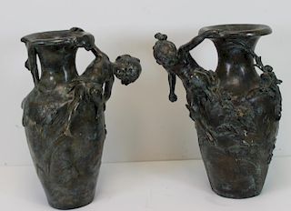 Near Pair of Patinated Bronze Figural Urns.
