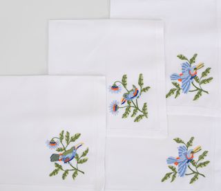 Hermes Circular Linen Tablecloth and a Set of Twelve Napkins Embroidered with Toucans