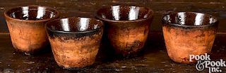 Set of four redware custard cups