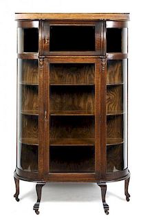 A Victorian Bow Front Oak Vitrine, Height 69 x width 40 x depth 13 inches.