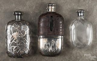 Three glass flasks, to include an example with sterling silver and an alligator skin cover