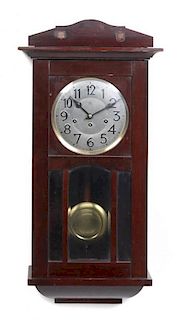 A Case Wall Clock, Junghans, Height 29 3/8 x width 14 5/8 x depth 8 3/8 inches.