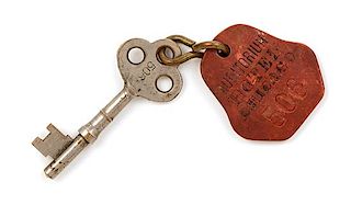 A Louis Sullivan Auditorium Building Brass Door Key and Fob Length 6 3/8 x width 1 3/4 inches.