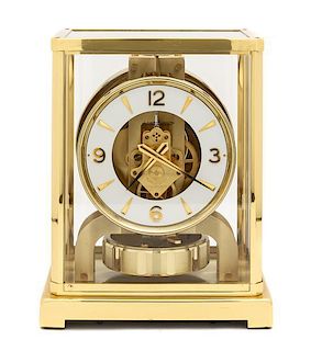 A Swiss Brass Atmos Clock, LeCoultre, Height of clock 8 3/4 inches.