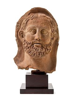 * An Etruscan Terra Cotta Votive Head of a Bearded Man Height 12 1/4 inches.