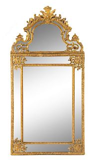 A Regence Style Giltwood Mirror Height 56 3/4 x width 28 1/2 inches.