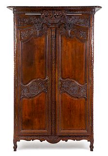 A French Provincial Carved Walnut Armoire Height 87 3/4 x width 51 x depth 19 1/2 inches.