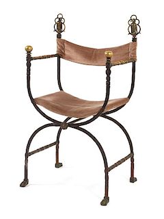 An Iron and Brass Curule Armchair Height 40 1/2 x width 21 1/2 x depth 15 inches.