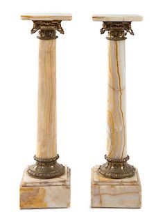 A Pair of Gilt Bronze Mounted Onyx Pedestals Height 45 x width of top 11 3/4 x depth 11 3/4 inches.