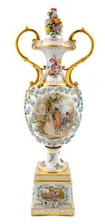 A German Porcelain Flower Encrusted Covered Urn Height 29 inches.