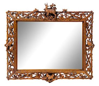 A Black Forest Carved Mirror Height 37 x width 39 inches.